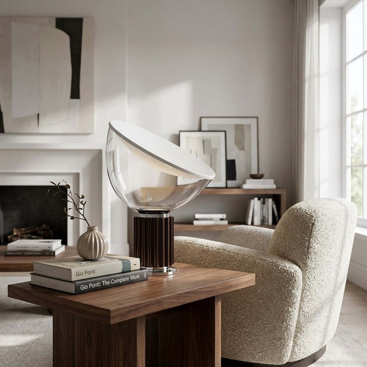 Coffee-base Taccia table lamp on a walnut end table beside a cream lounge chair in a modern living room