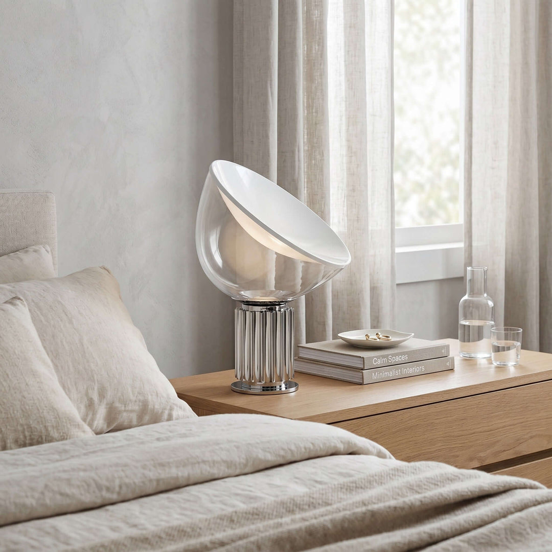 Silver Taccia glass table lamp on a wood bedroom nightstand beside neutral linen bedding