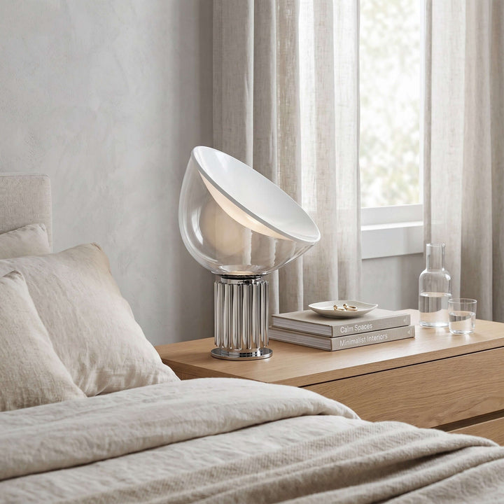 Silver Taccia glass table lamp on a wood bedroom nightstand beside neutral linen bedding