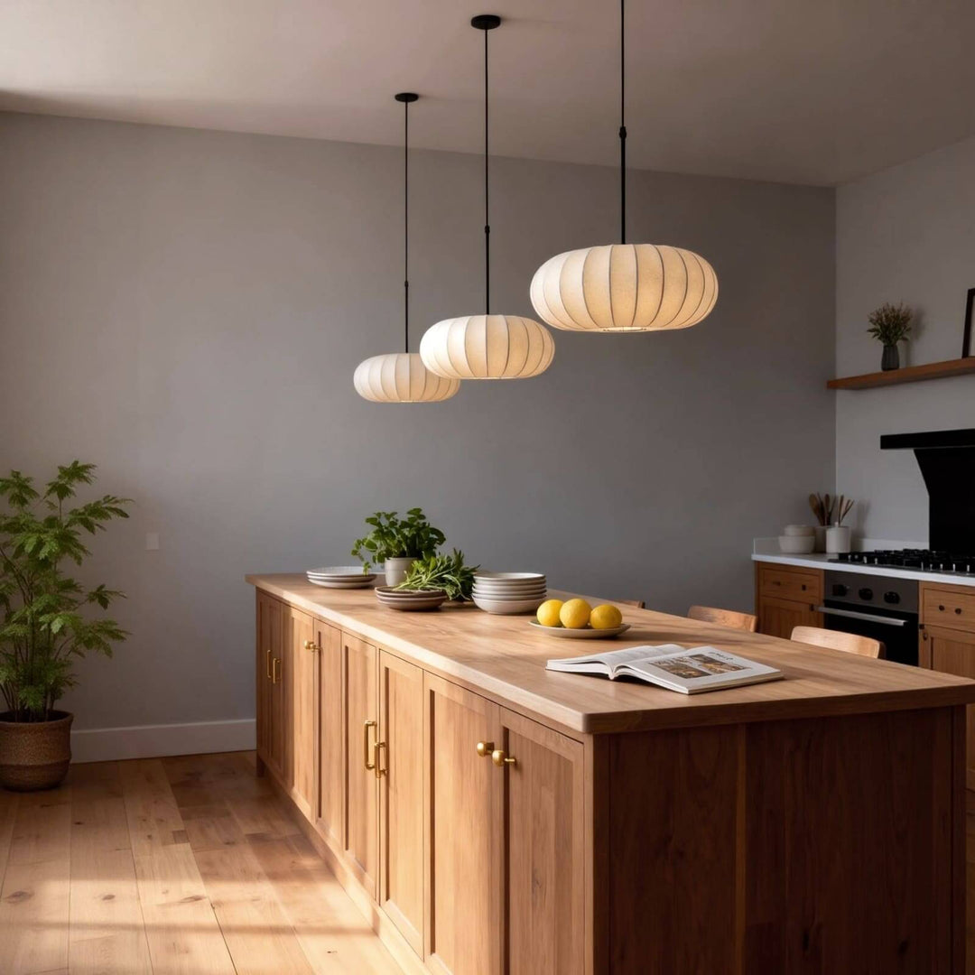 Three Verona silk pendant lights in different sizes above a large wooden kitchen island