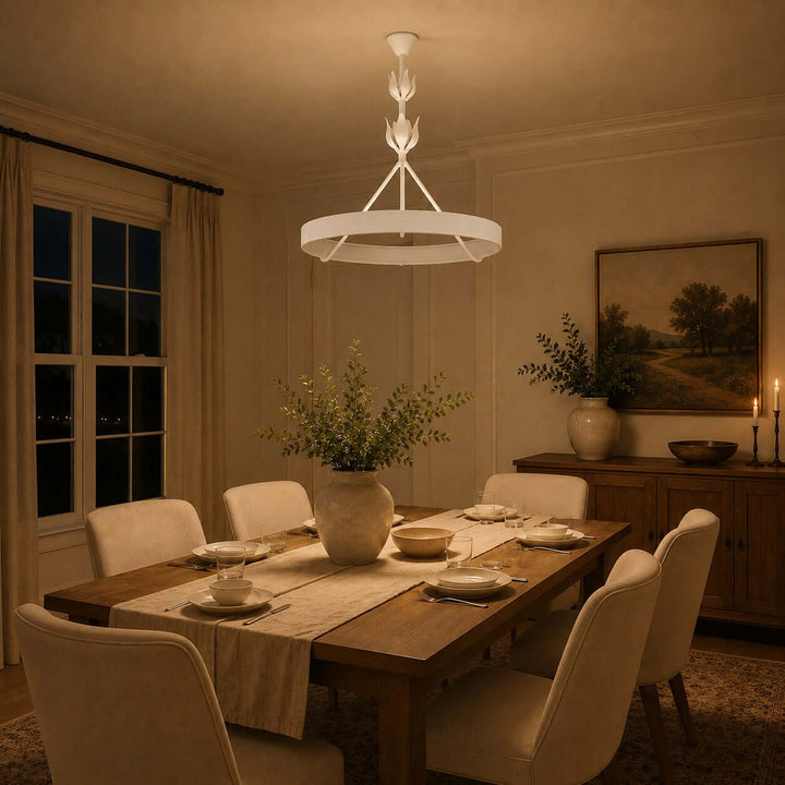 White Tinsley dining room chandelier illuminating a set wood table in a warm evening interior.