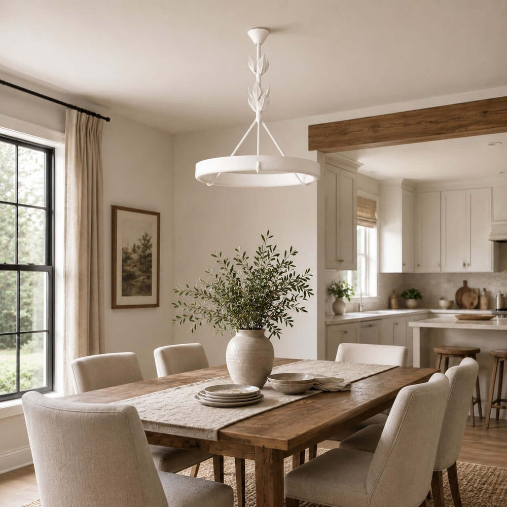 White Tinsley dining room chandelier above a rustic wood table in a bright open dining space.