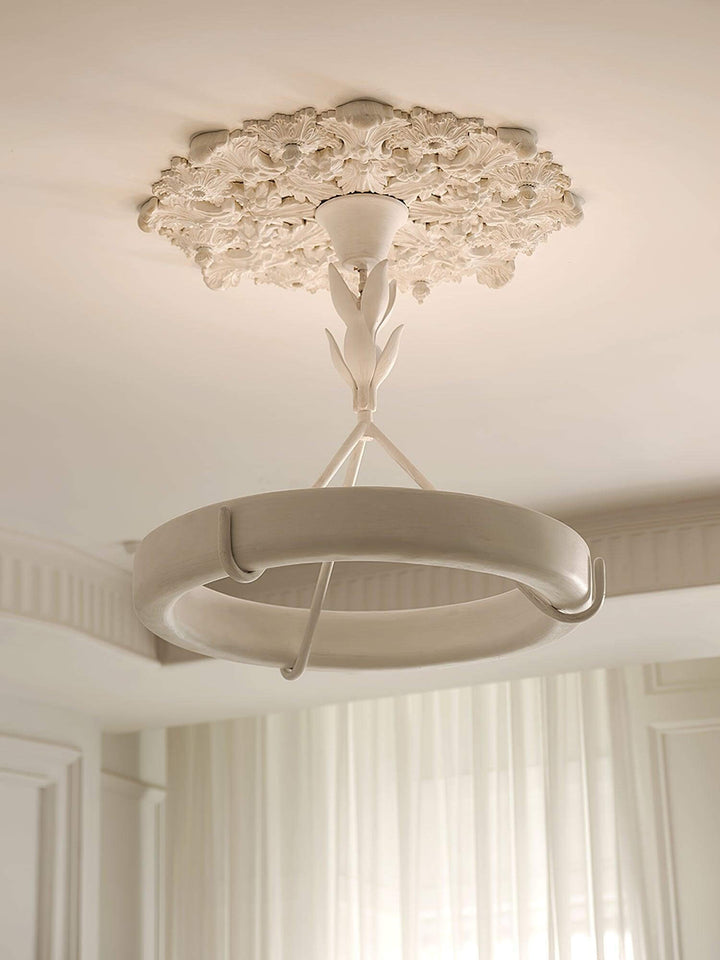 Close-up of the Tinsley chandelier’s sculpted leaf stem, plaster ring, supports, and floral ceiling medallion.