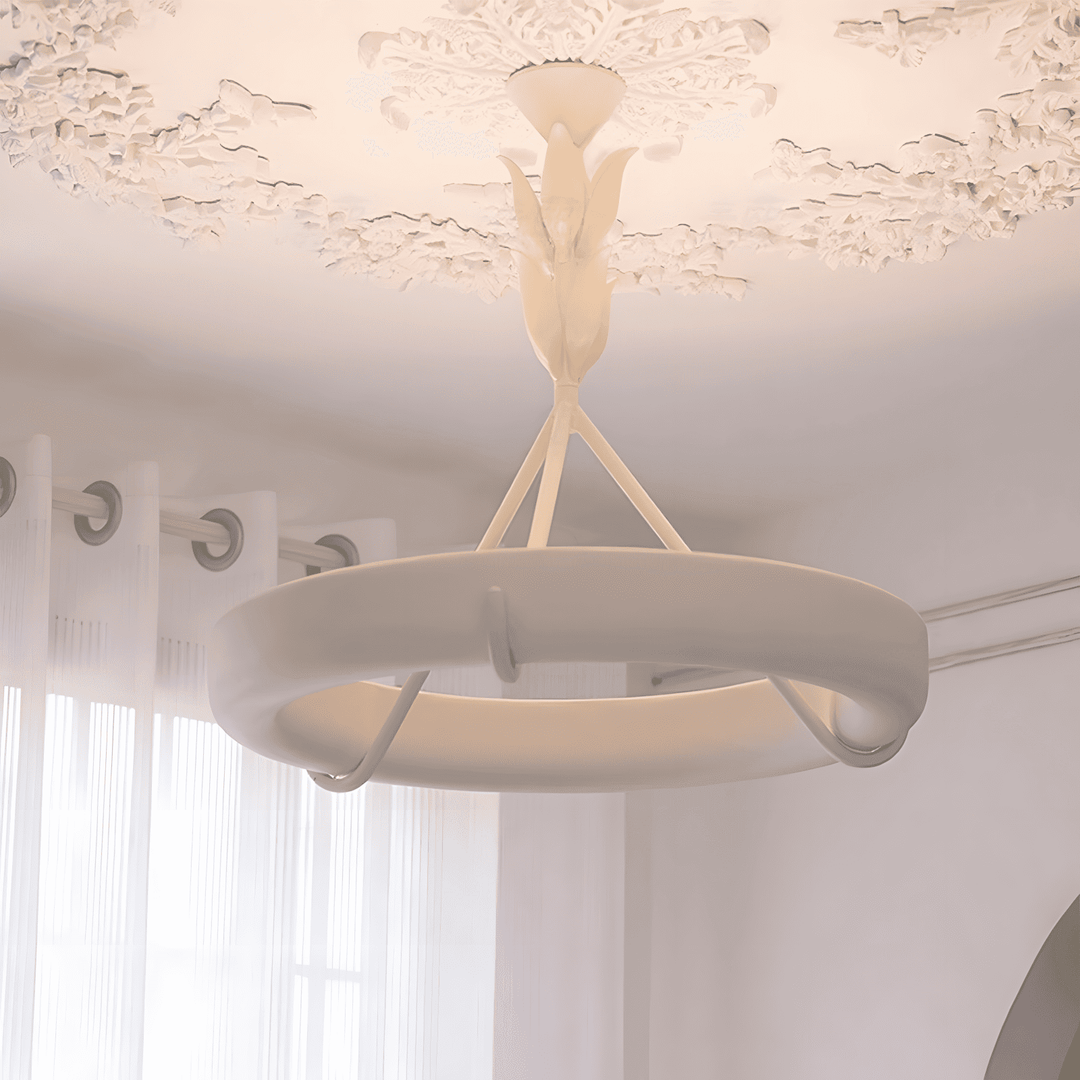 Close-up of warm LED light glowing inside the Tinsley chandelier’s white plaster ring.