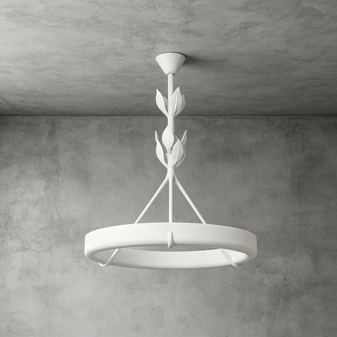 White Tinsley plaster chandelier with a circular ring and stacked leaf details against a gray concrete wall.