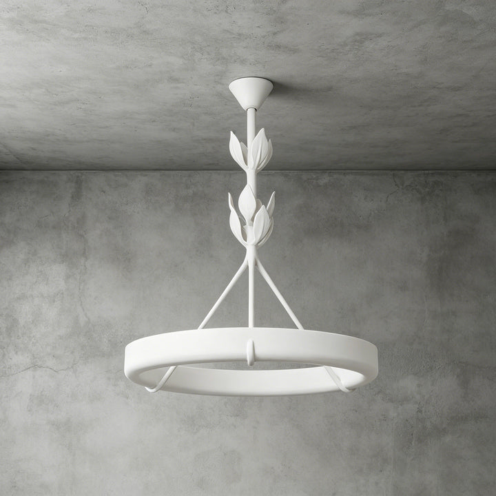 White Tinsley plaster chandelier with a circular ring and stacked leaf details against a gray concrete wall.