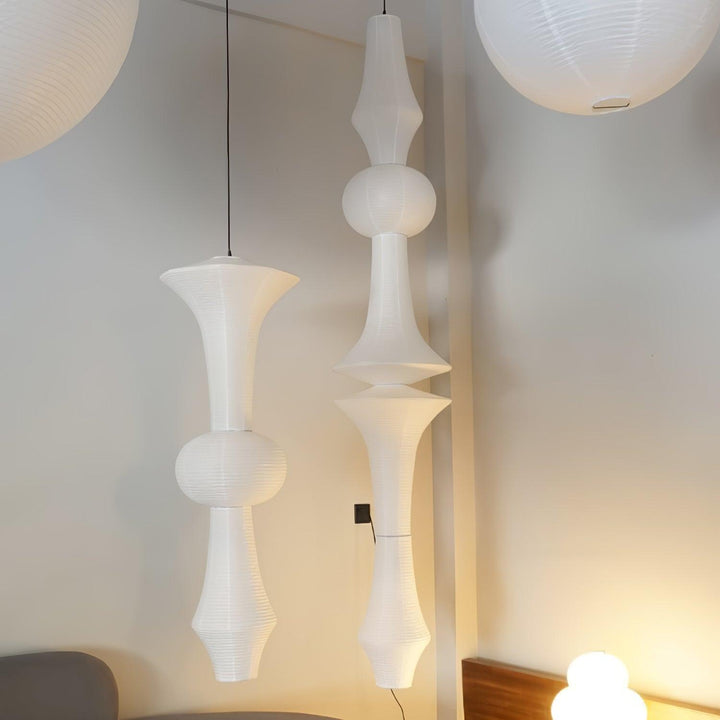 Two white Washi paper pendant lights with contrasting sculptural profiles in a bright neutral interior