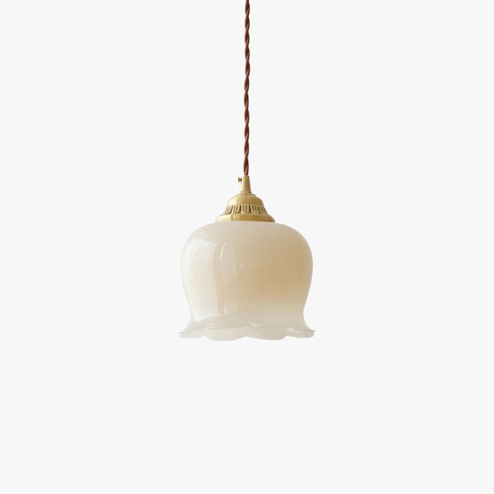 Valley flower pendant light with a beige resin shade, antique brass cap, and twisted cord on a white background