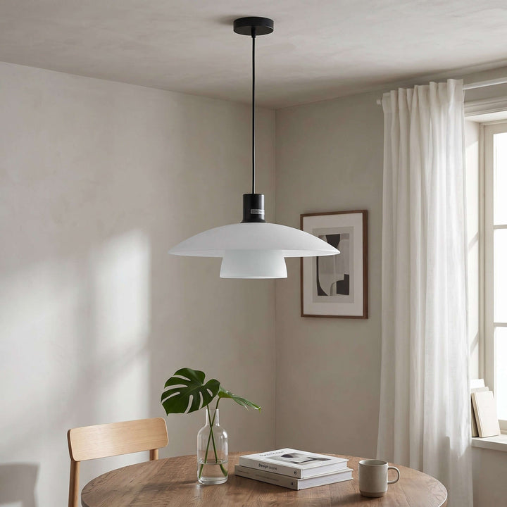 Wide Verona pendant lamp above a round wood dining table beside a bright window