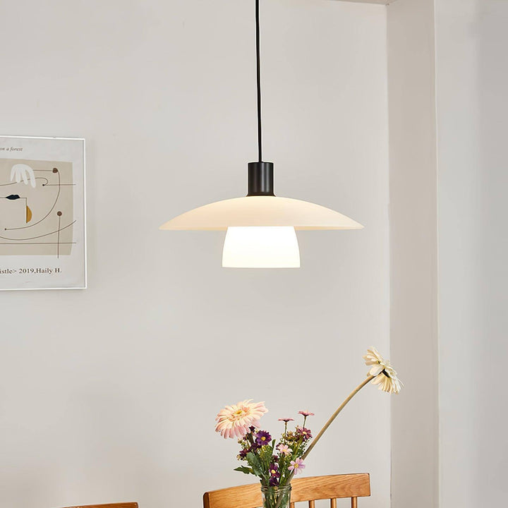 Glowing Verona pendant light centered between two arched windows in a neutral interior