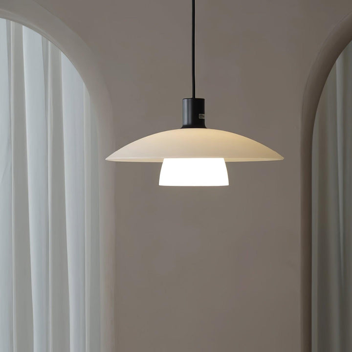 Verona pendant light with a broad white shade framed by arched windows and sheer curtains