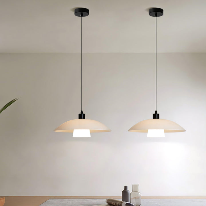 Two Verona pendant lights suspended symmetrically in a clean neutral dining space