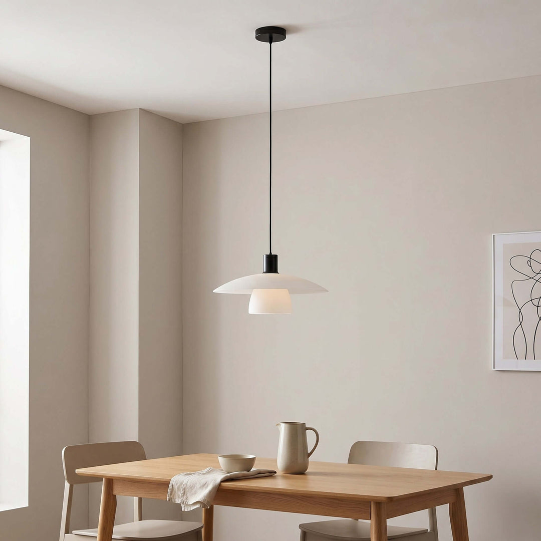 Verona pendant light above a rectangular wood dining table with a black canopy and cord