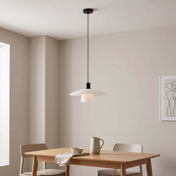 Verona pendant light above a rectangular wood dining table with a black canopy and cord