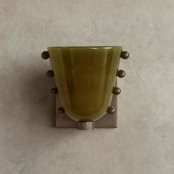 Front view of a green Vestra glass wall sconce with matching sphere accents