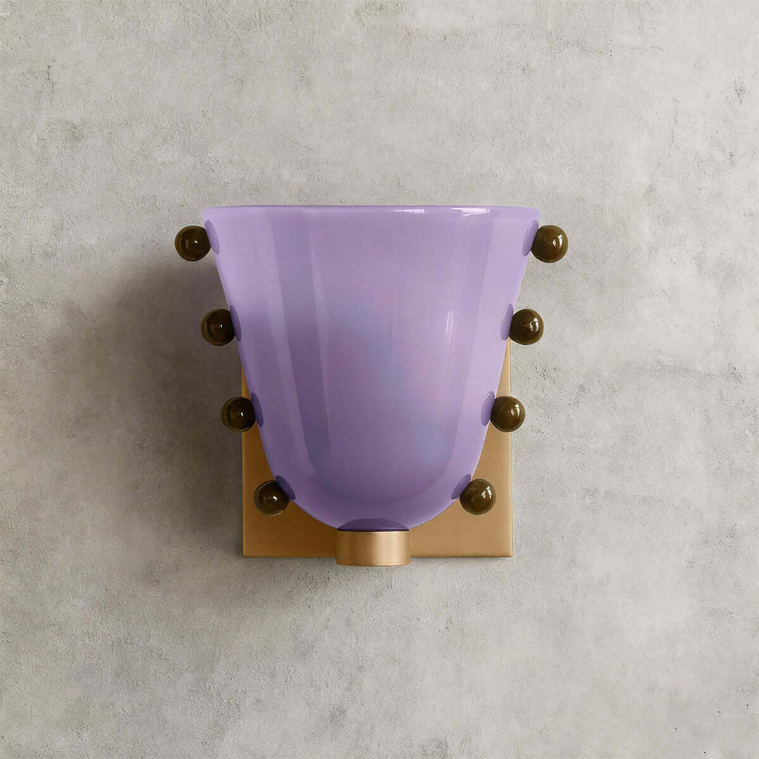 Purple Vestra glass wall sconce shown from the front with a gold backplate