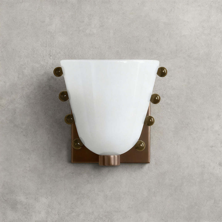 Front view of a white Vestra glass wall sconce with decorative sphere accents