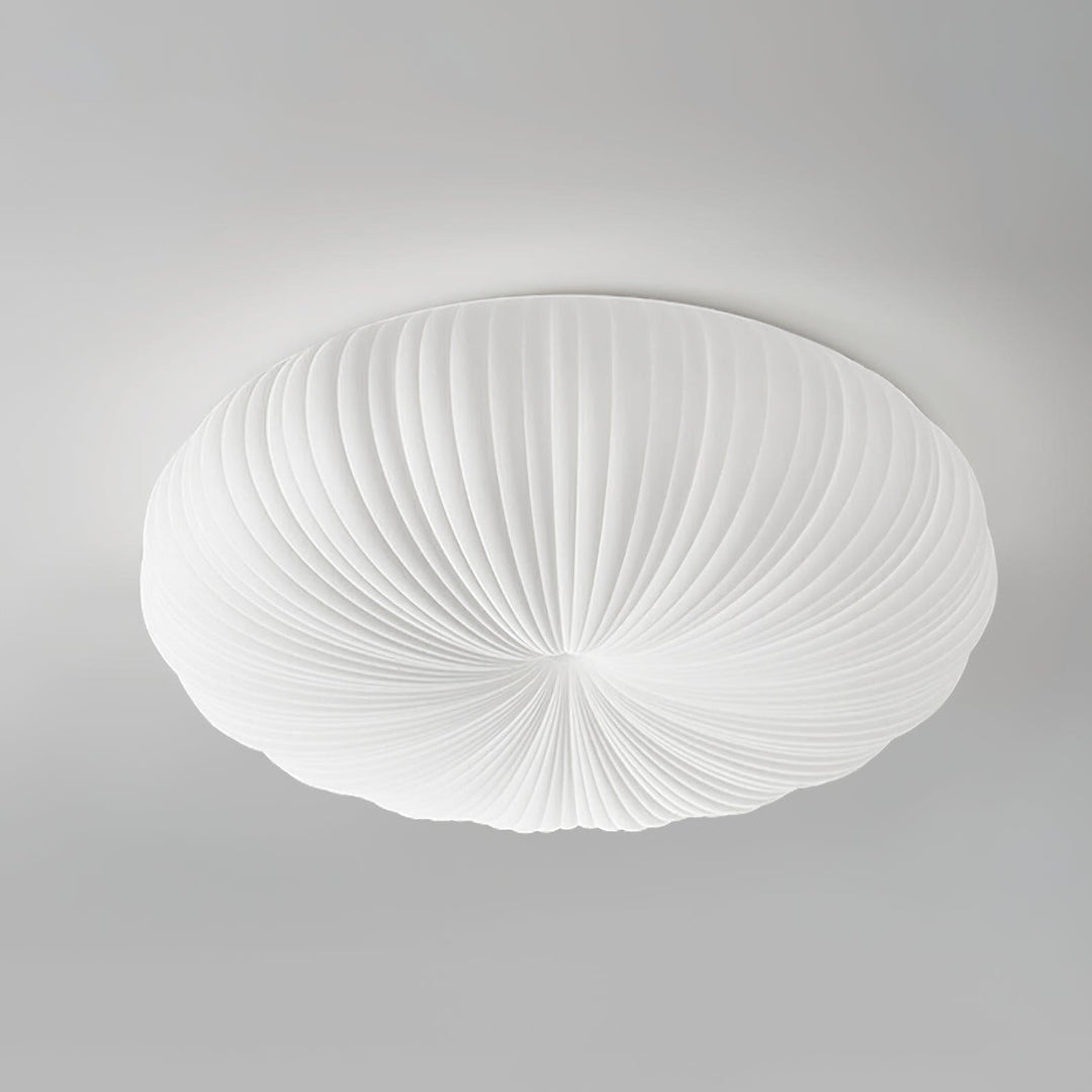 White round flush mount ceiling light with a pleated shade shown on a gray background.