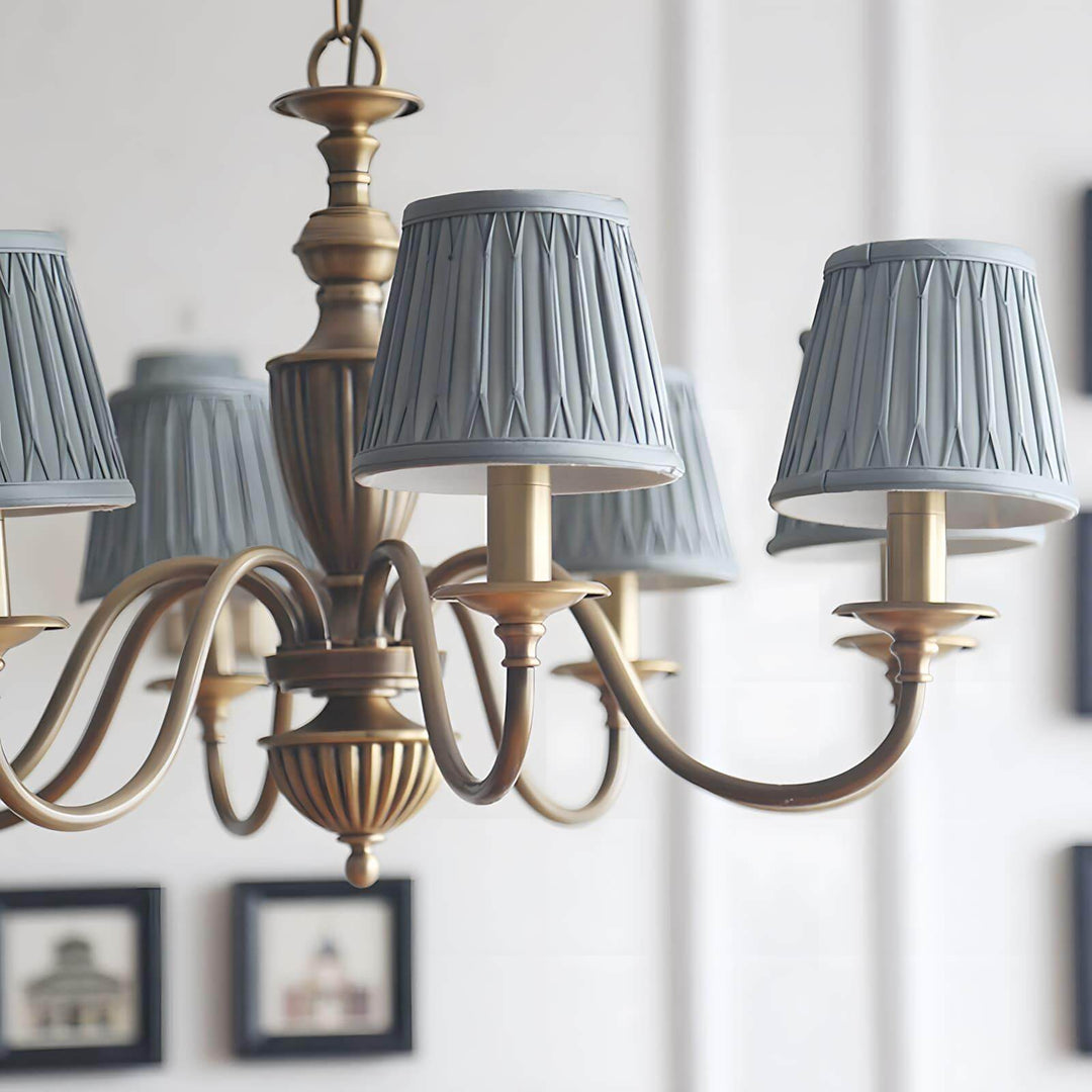 Close-up of blue pleated fabric shades on the Eryn brass chandelier.