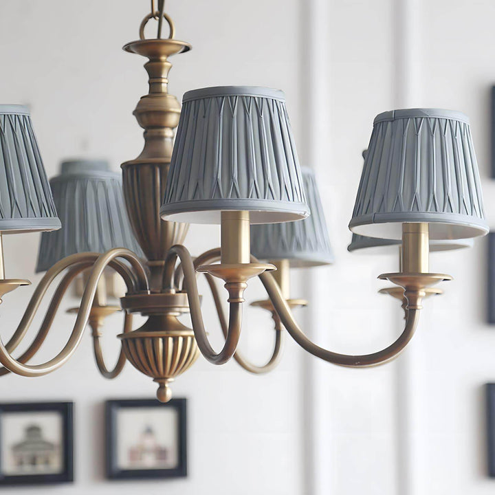 Close-up of blue pleated fabric shades on the Eryn brass chandelier.