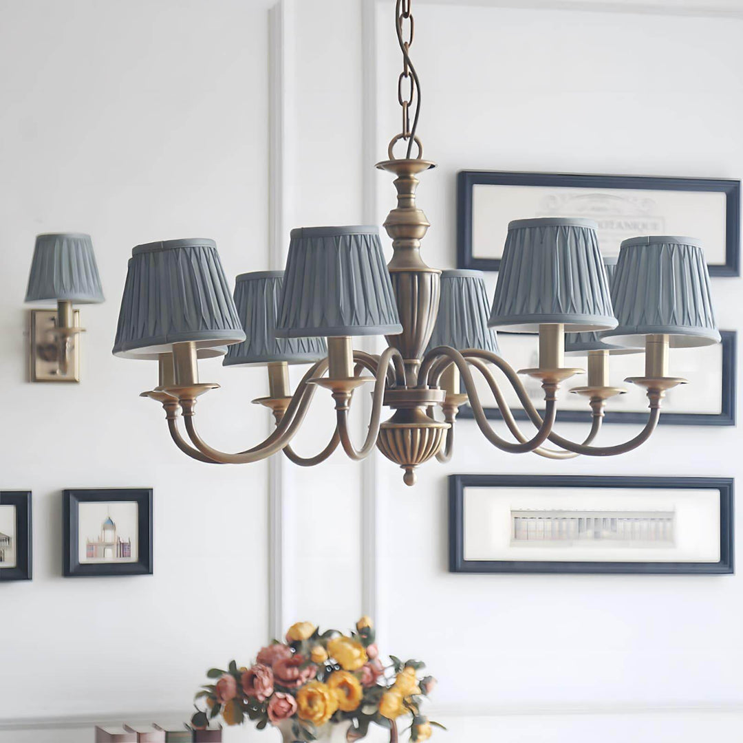 Blue shade Eryn chandelier with a brass frame shown in a room setting.
