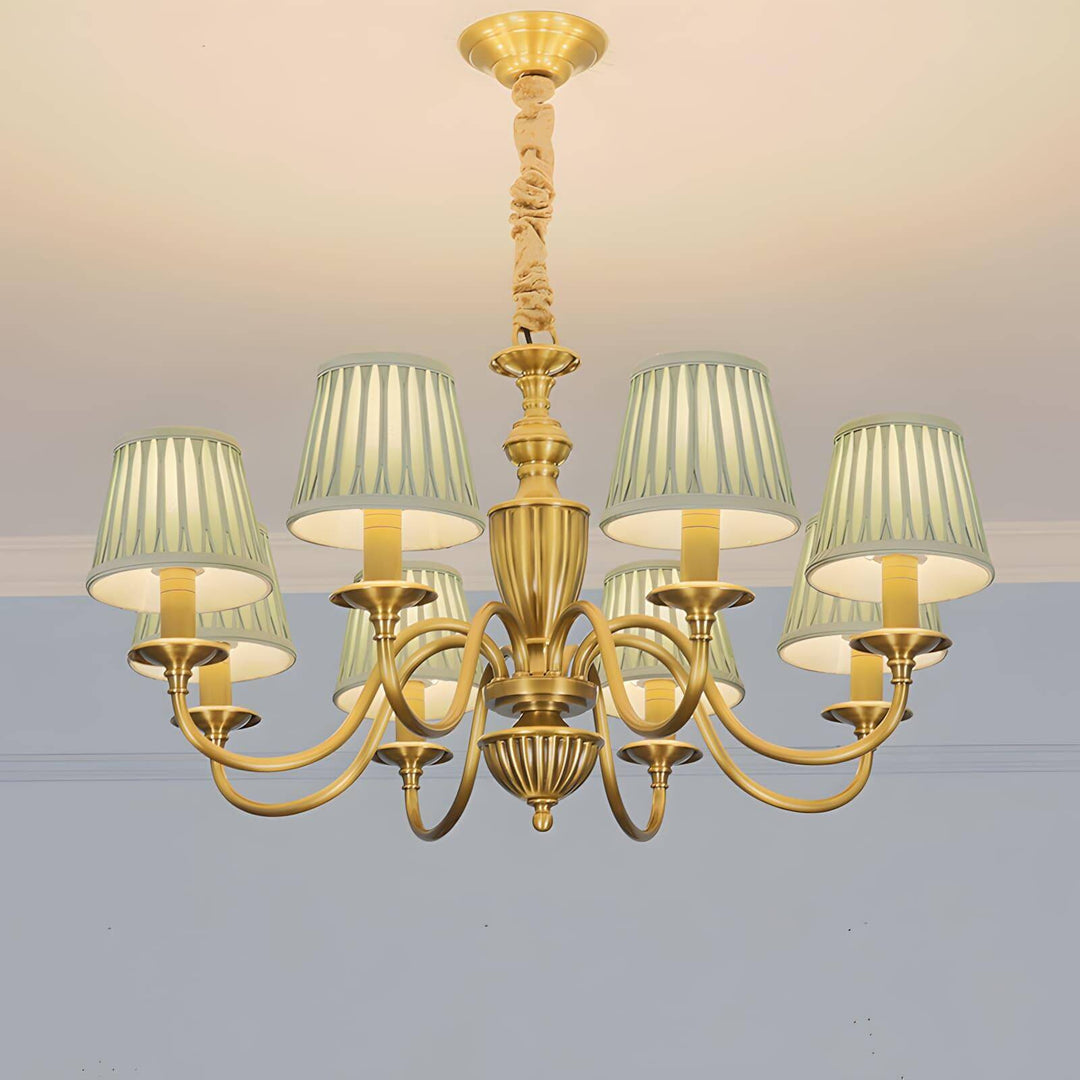 Brass Eryn chandelier with pleated fabric shades mounted close to a ceiling.