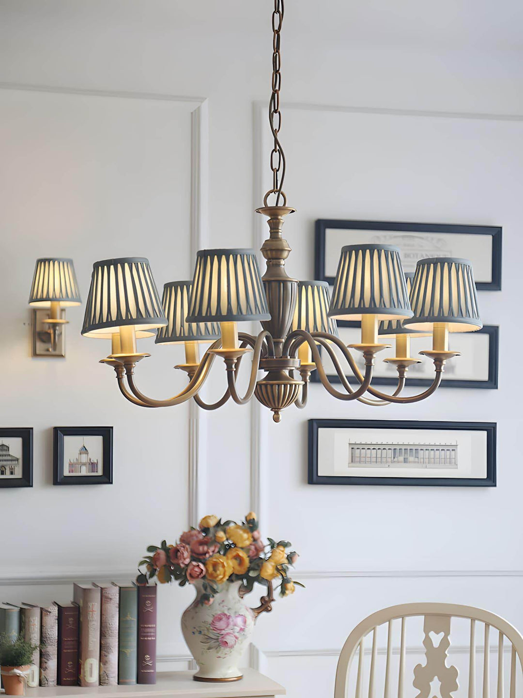 Eryn chandelier hanging over a dining table with framed wall art behind it.