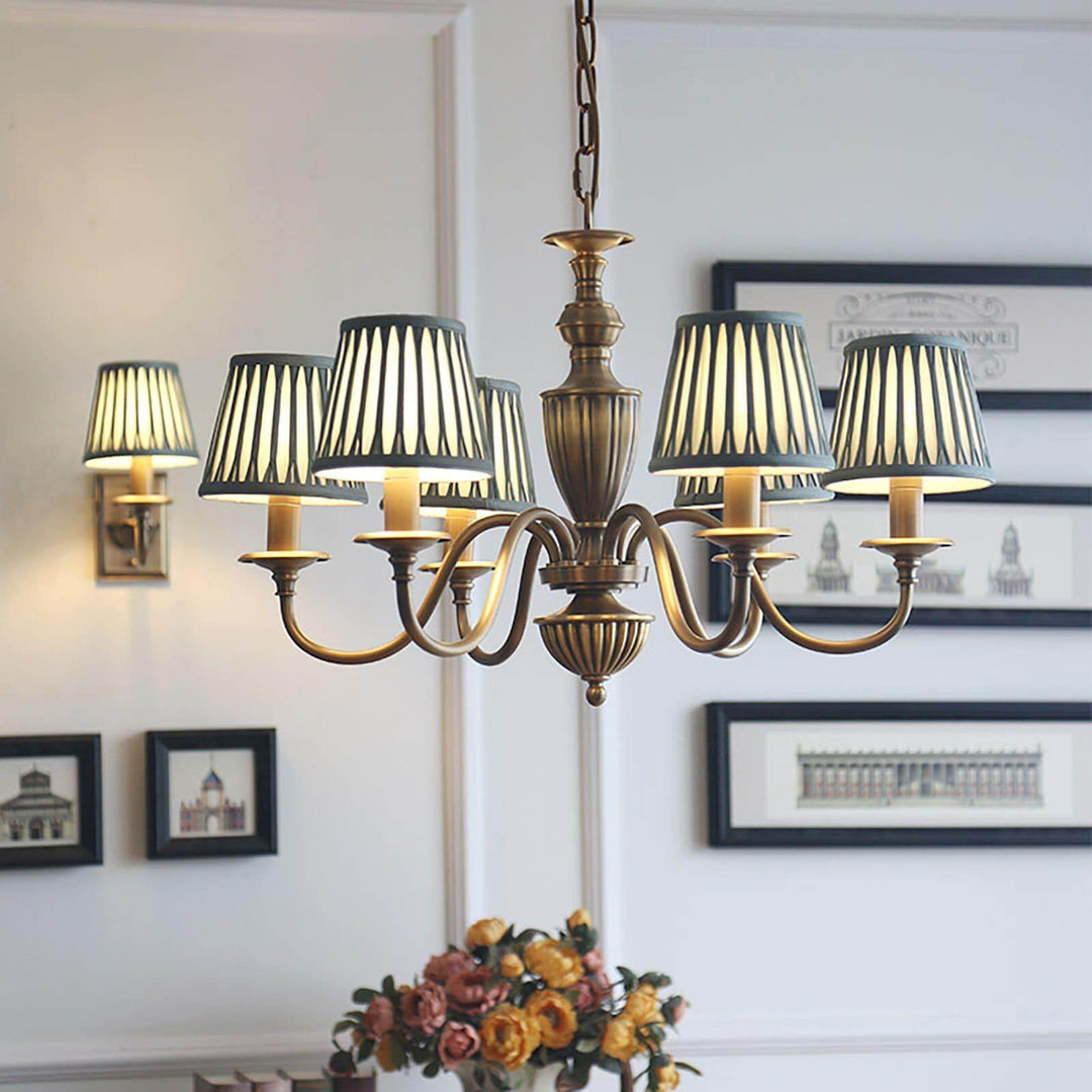 Eryn chandelier with striped shades hanging over a dining room table.