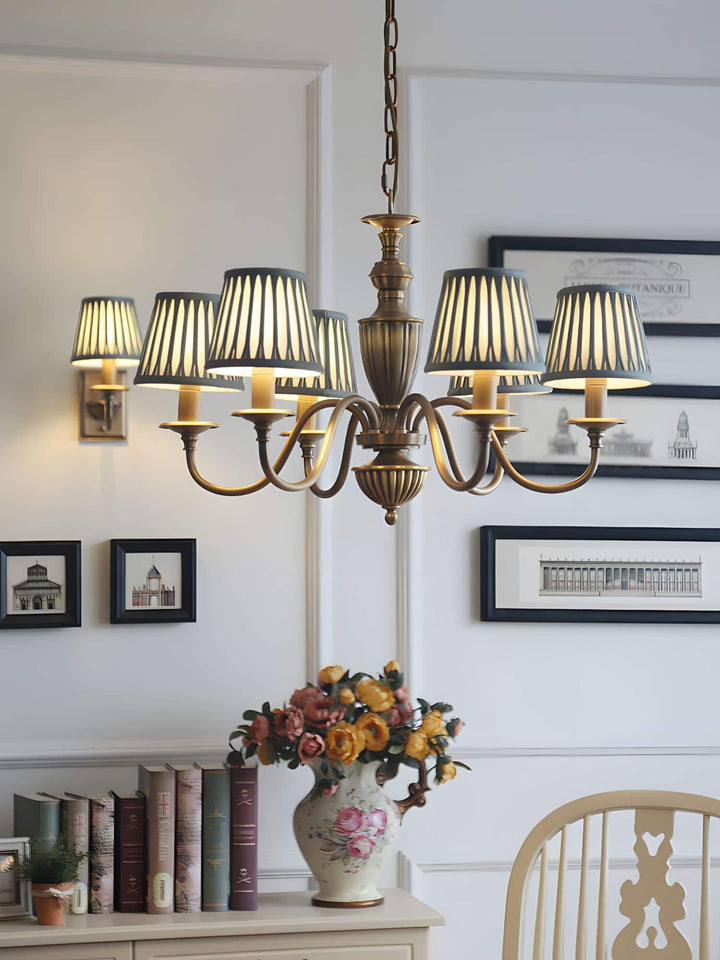 Vertical dining room scene with the Eryn chandelier above a table arrangement.