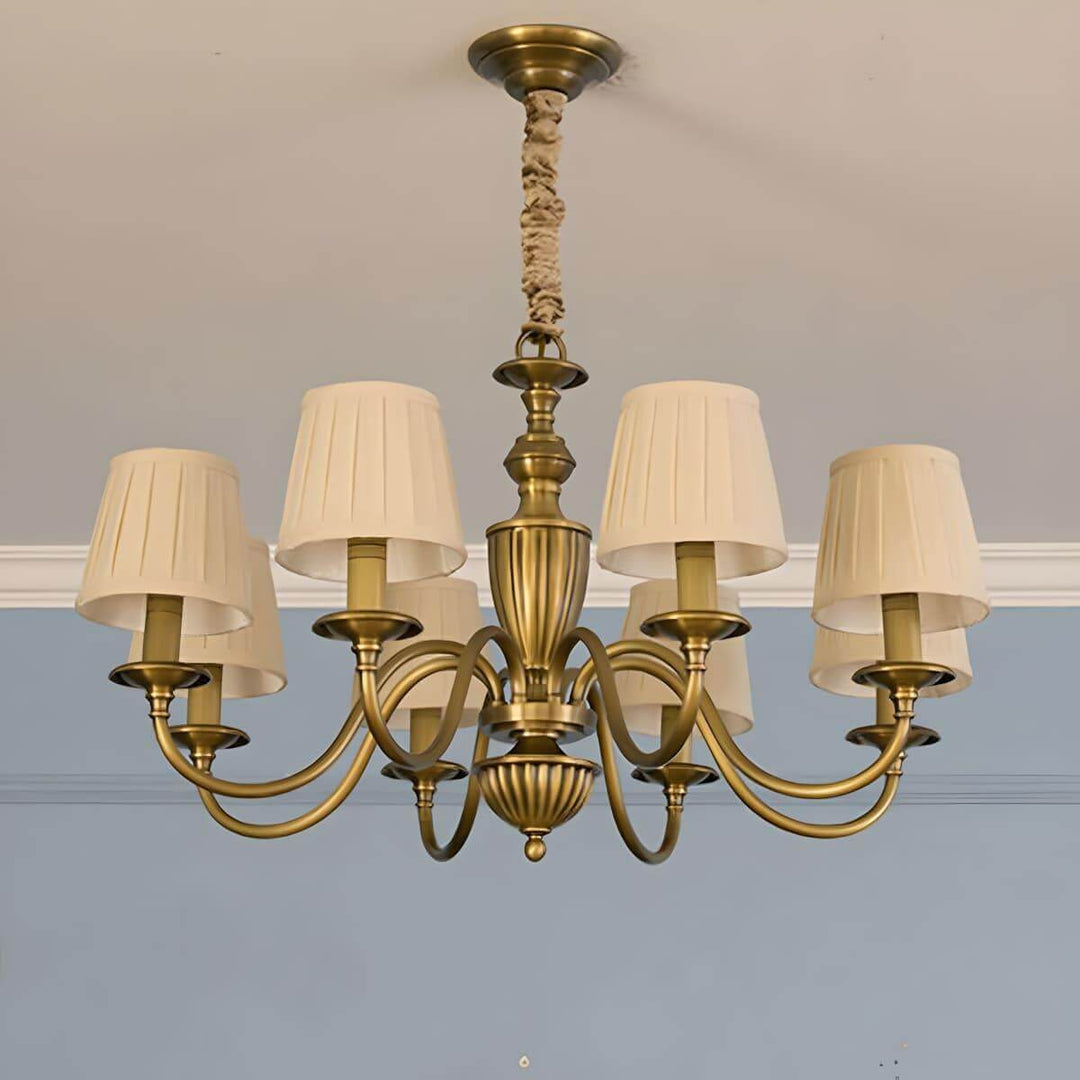 Eight-light Eryn chandelier with beige pleated shades and a brass frame.