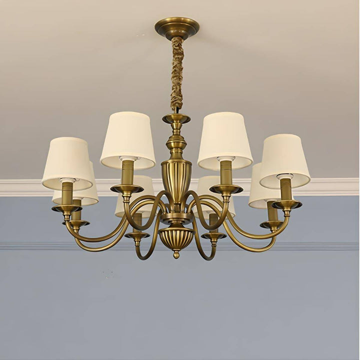 Eight-light Eryn chandelier with warm white shades and brass arms.