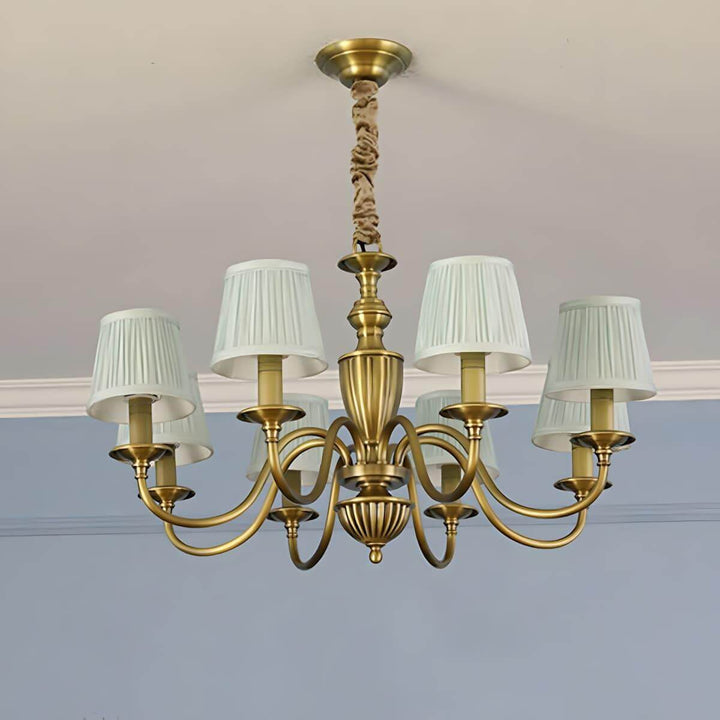Eight-light Eryn chandelier with white shades and a brass frame.