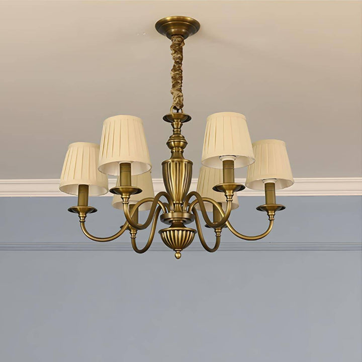 Six-light Eryn chandelier with beige shades and a brass frame.