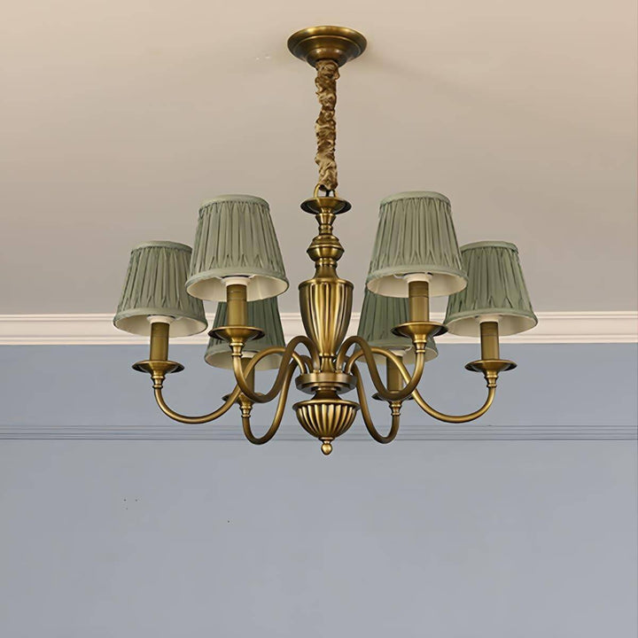 Six-light Eryn chandelier with green pleated shades and a brass frame.