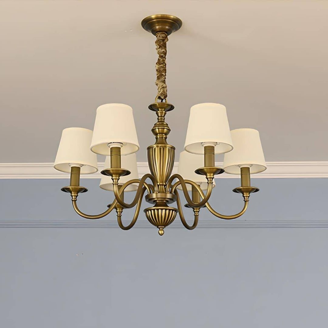Six-light Eryn chandelier with warm white shades and a brass frame.