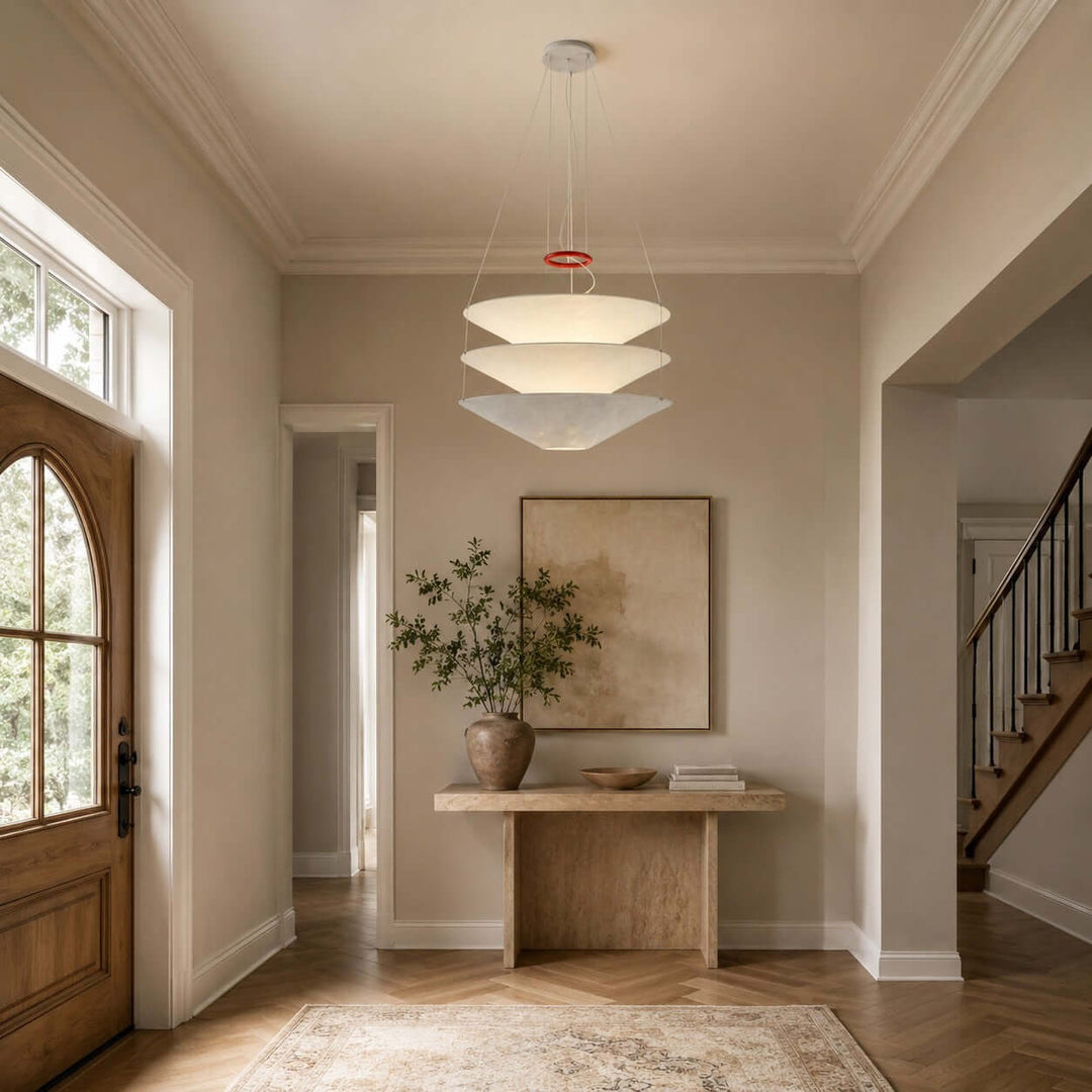 Floating pendant light glowing above an entry console in a hallway.