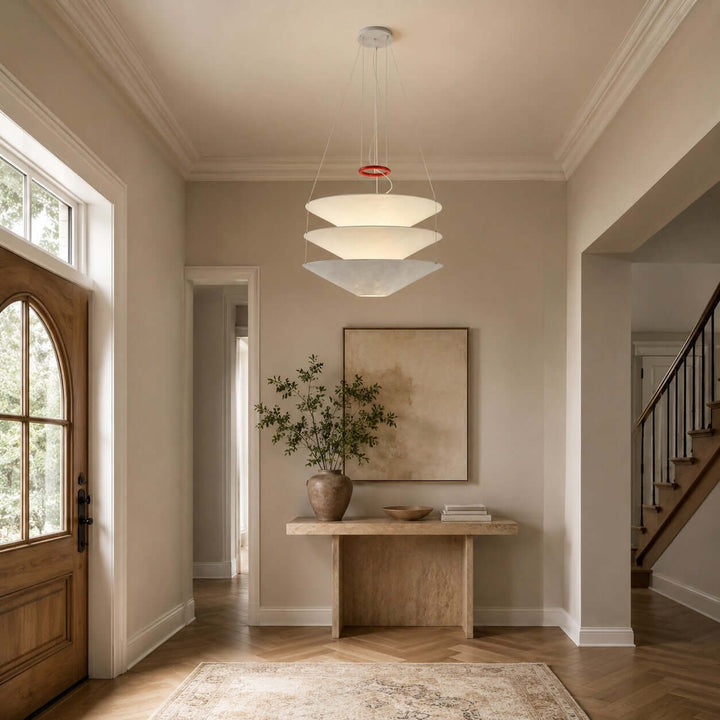 Floating pendant light glowing above an entry console in a hallway.