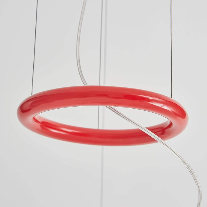 Close-up of the red ring accent and suspension wires on the pendant light.