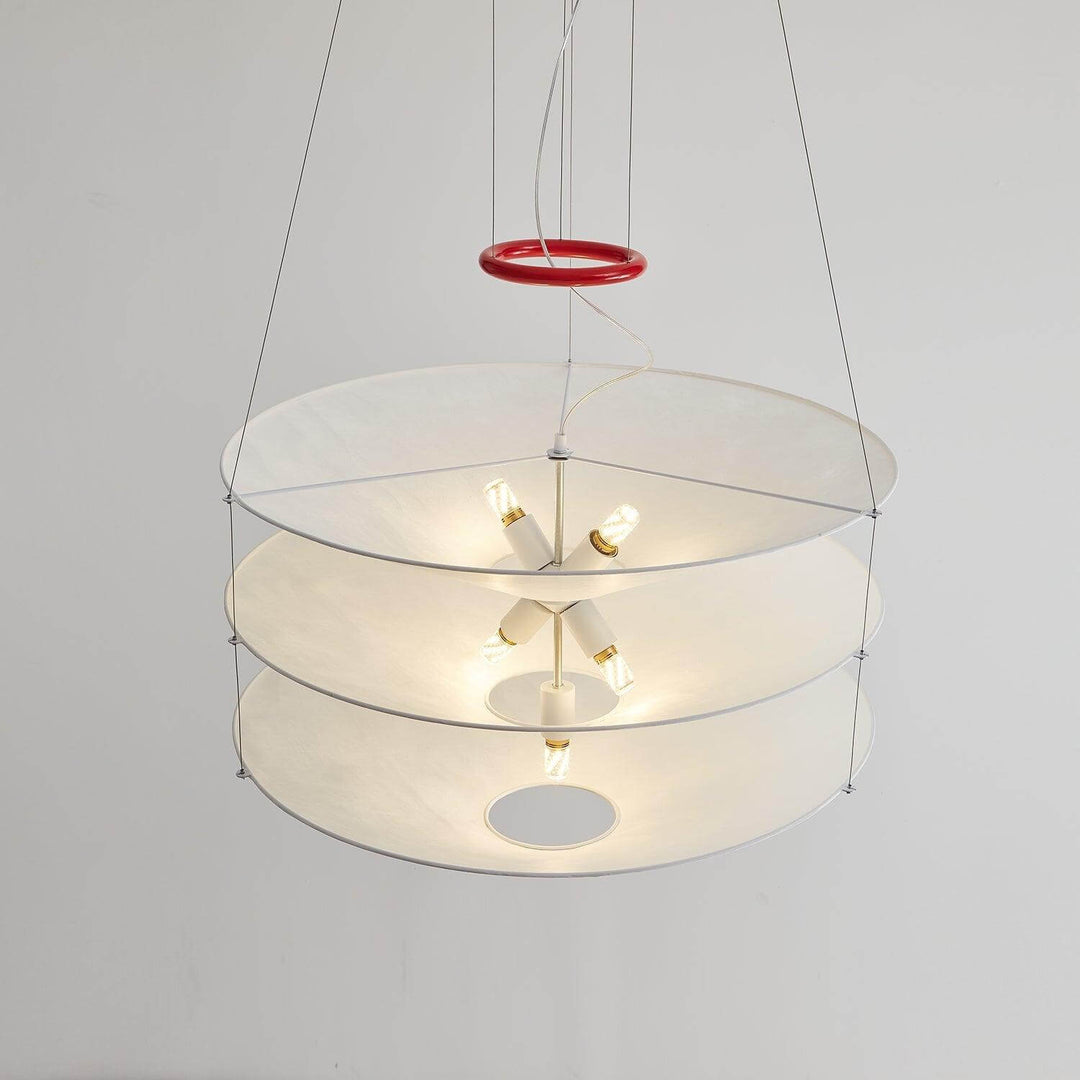 Underside view of the pendant light with a red top ring and glowing shades.