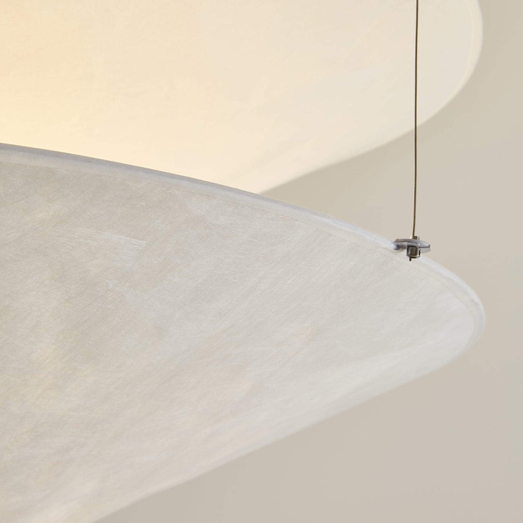 Close-up of the white shade edge and wire connector on the pendant light.