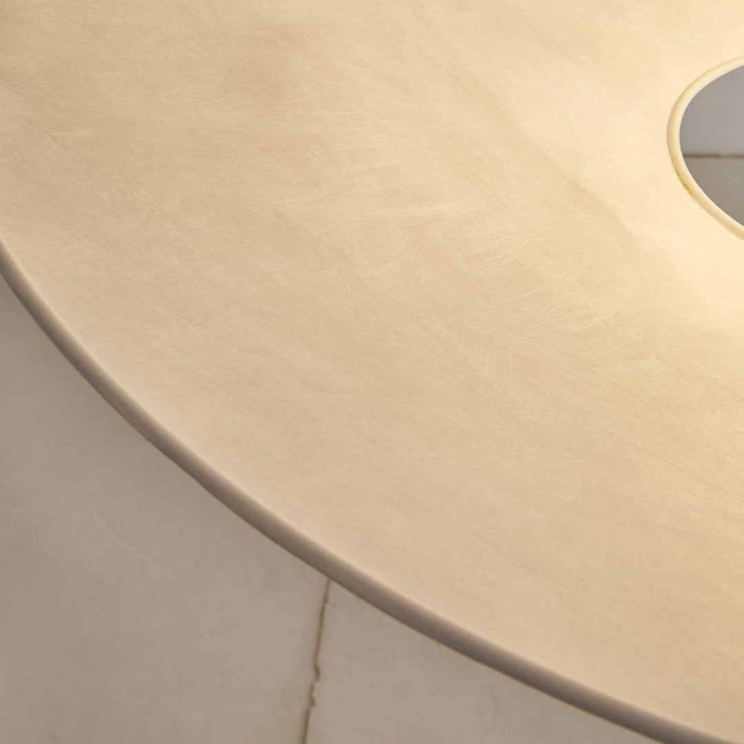 Close-up of the textured white shade surface on the pendant light.