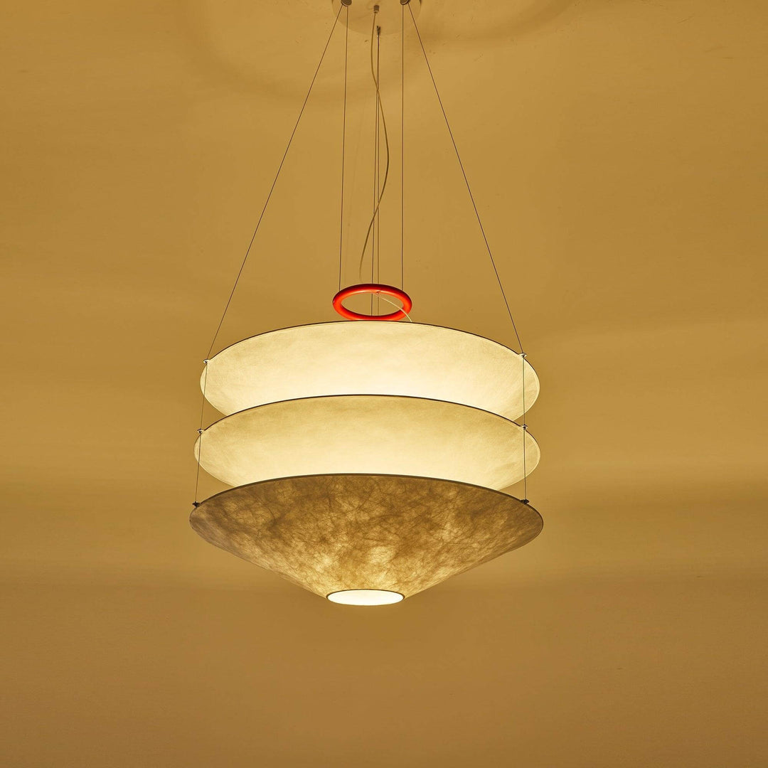 Single floating pendant light glowing against a warm yellow wall.