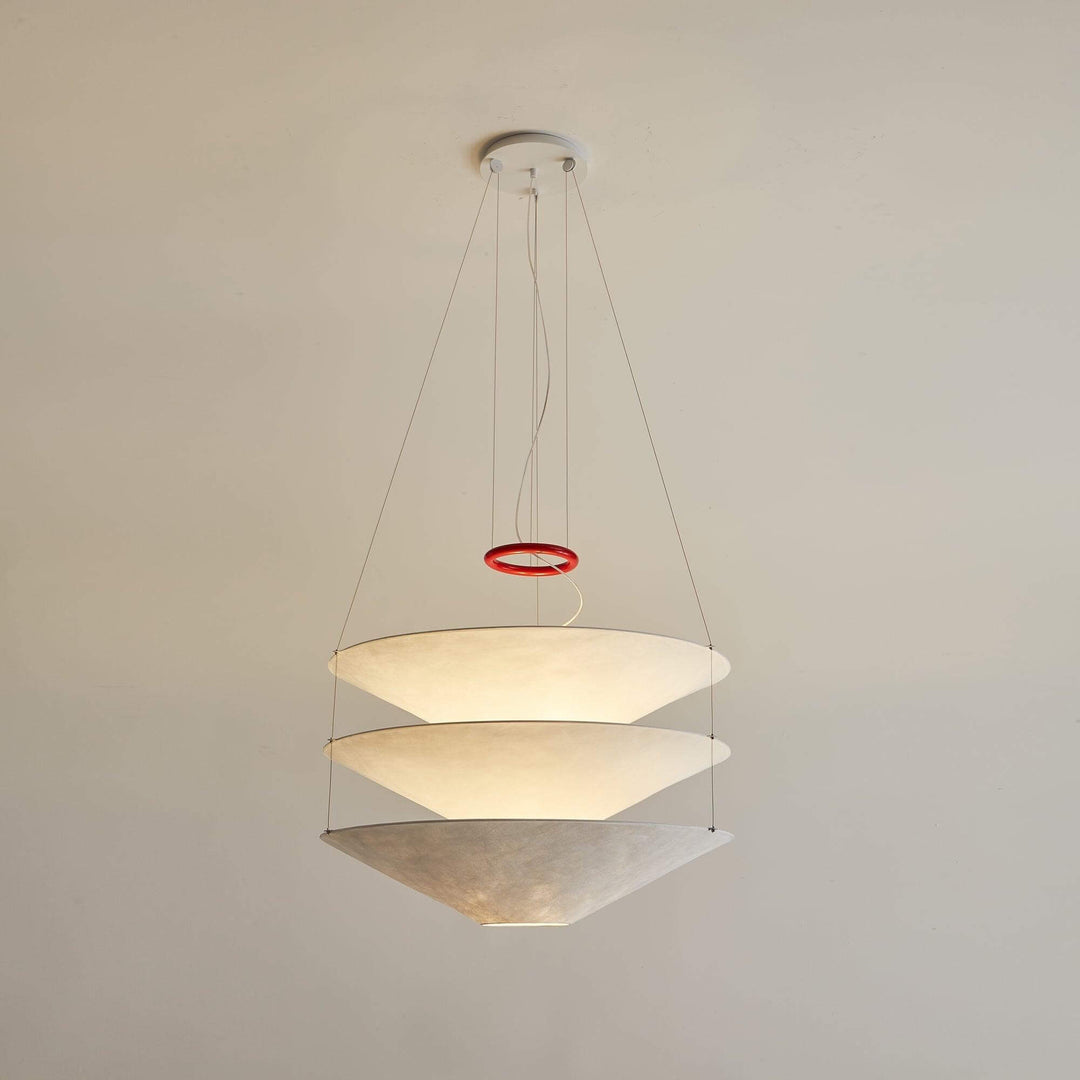 White floating pendant light with layered shades shown against a plain wall.