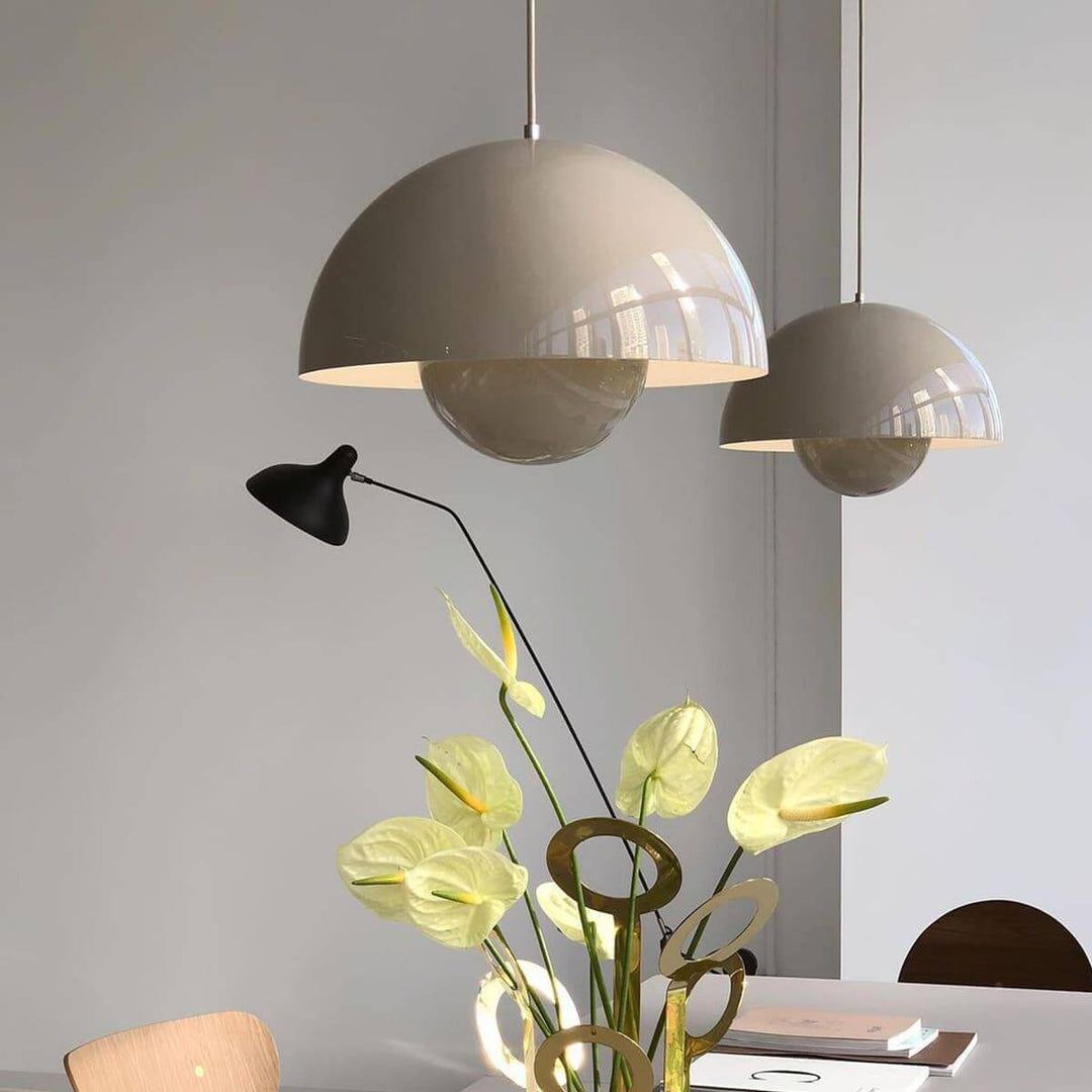 Beige gray Flowerpot pendant lamps shown above a dining table.