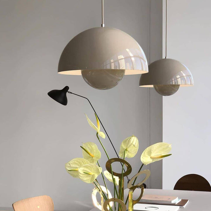 Beige gray Flowerpot pendant lamps shown above a dining table.