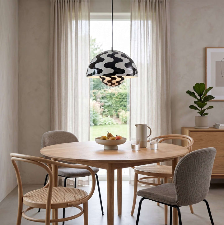 Black and white Flowerpot pendant lamp shown above a round dining table.