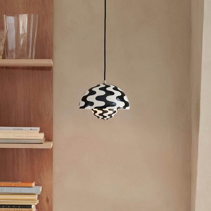 Black and white patterned Flowerpot pendant lamp shown near a shelf.