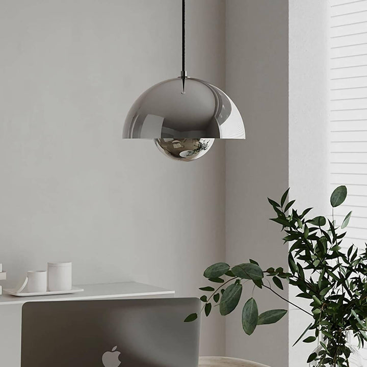 Chrome Flowerpot pendant lamp shown near indoor plants.