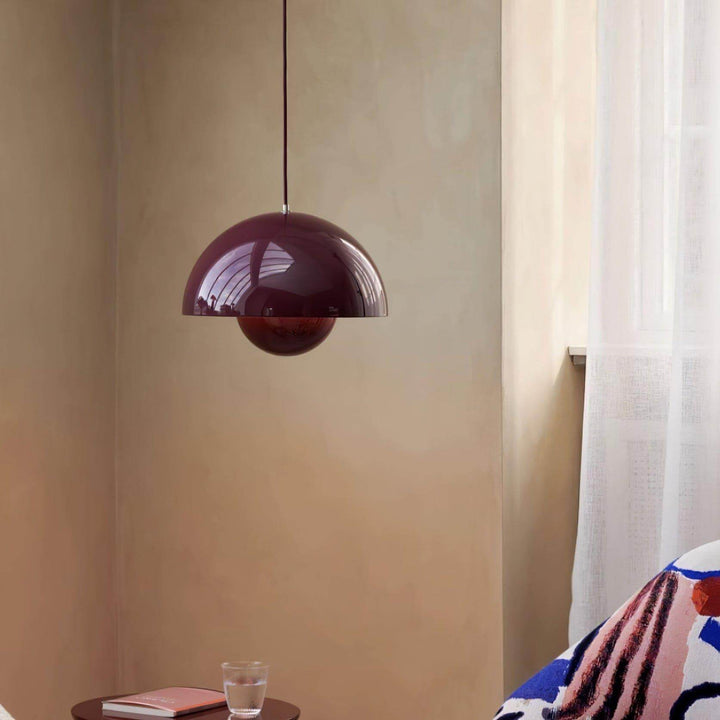 Glossy burgundy Flowerpot pendant lamp shown against a wall.