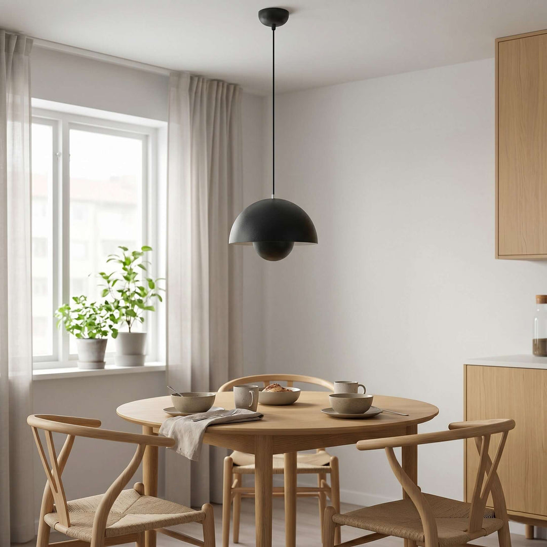 Matte black Flowerpot pendant lamp shown above a dining table.